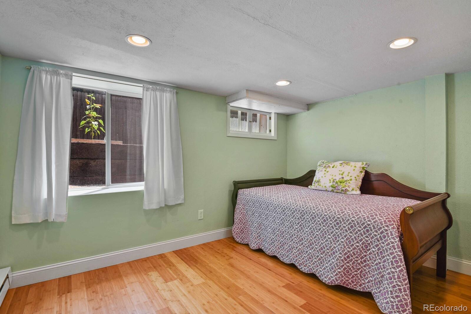 3615 Lowell Boulevard Denver, CO 80211 - Photo 16 of 23 a bedroom with a bed and a window