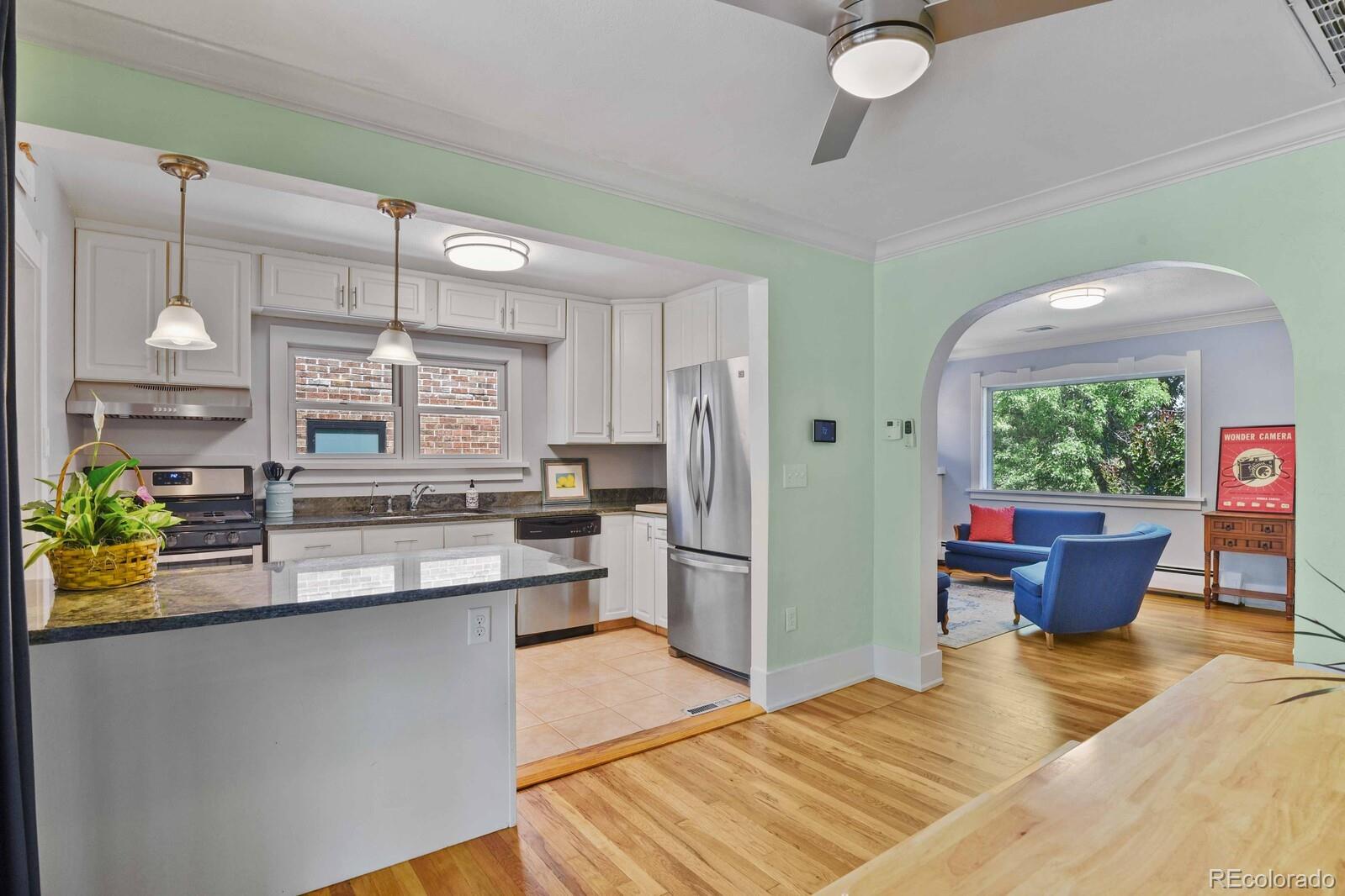 3615 Lowell Boulevard Denver, CO 80211 - Photo 9 of 23 a kitchen with stainless steel appliances granite countertop a sink window and wooden floor