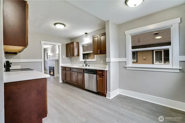 a large kitchen with a stove top oven and sink