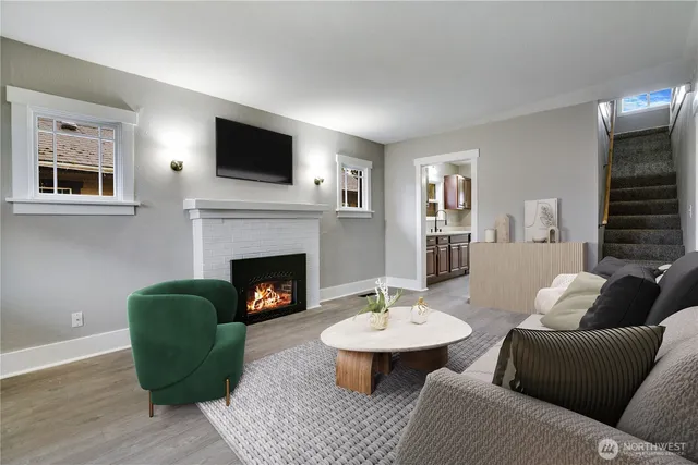 a living room with furniture a fireplace and a flat screen tv