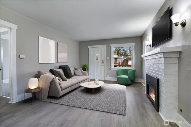 a living room with furniture fireplace and window