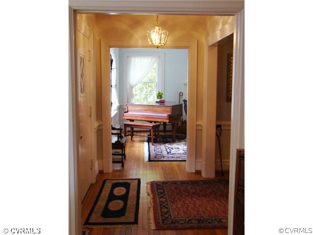 4515 Butte Road Richmond, VA 23235 - Photo 15 of 15 a view of a hallway with wooden floor and a large mirror