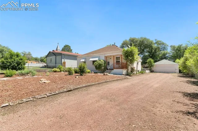 a front view of a house with a yard and a garage
