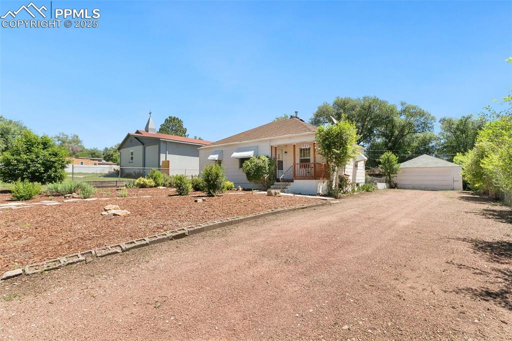 623 Swope Avenue Colorado Springs, CO 80909 - Photo 1 of 39 a front view of a house with a yard and a garage