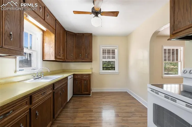 a kitchen with a sink stove and cabinets