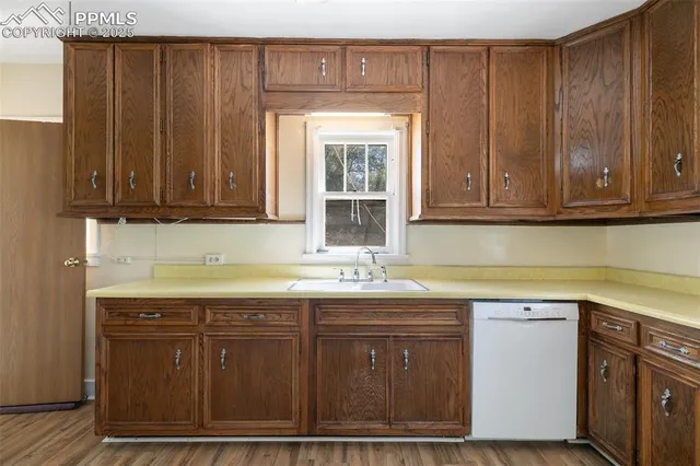 a kitchen with stainless steel appliances granite countertop wooden cabinets a sink and dishwasher