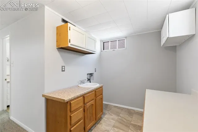 a utility room with a sink a washer and dryer