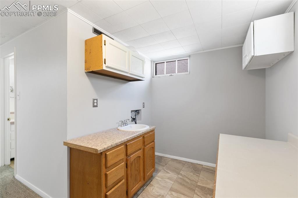 623 Swope Avenue Colorado Springs, CO 80909 - Photo 17 of 39 a utility room with a sink a washer and dryer