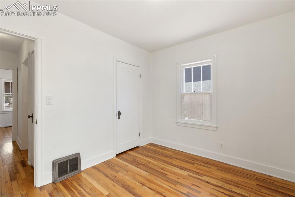 623 Swope Avenue Colorado Springs, CO 80909 - Photo 20 of 39 a view of empty room with wooden floor and fan