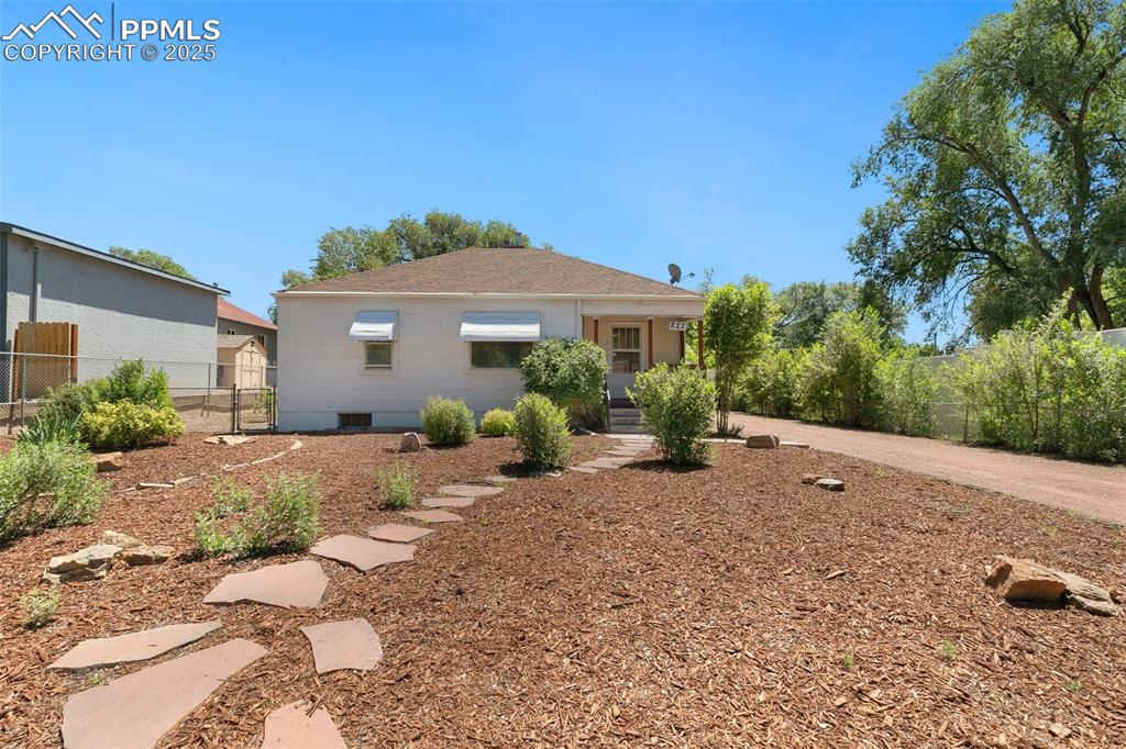 623 Swope Avenue Colorado Springs, CO 80909 - Photo 2 of 39 a front view of a house with a yard
