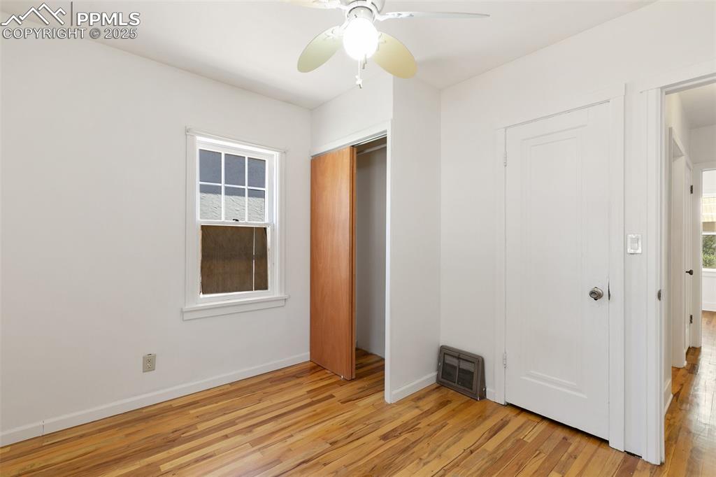 623 Swope Avenue Colorado Springs, CO 80909 - Photo 23 of 39 a view of an empty room with wooden floor and a window