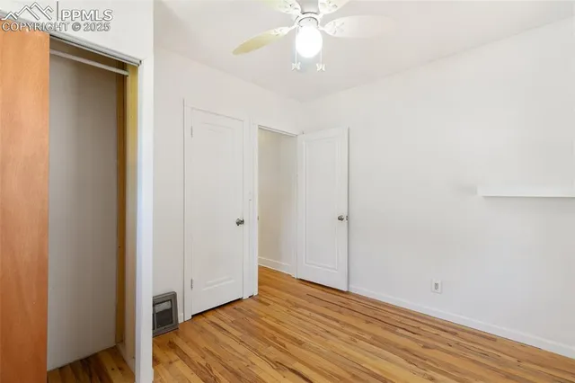 a view of a room with wooden floor