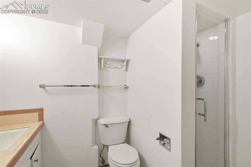 623 Swope Avenue Colorado Springs, CO 80909 - Photo 30 of 39 a bathroom with a toilet and a shower