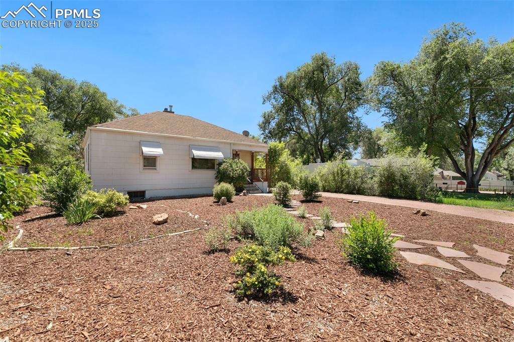 623 Swope Avenue Colorado Springs, CO 80909 - Photo 3 of 39 a front view of house with garden and trees
