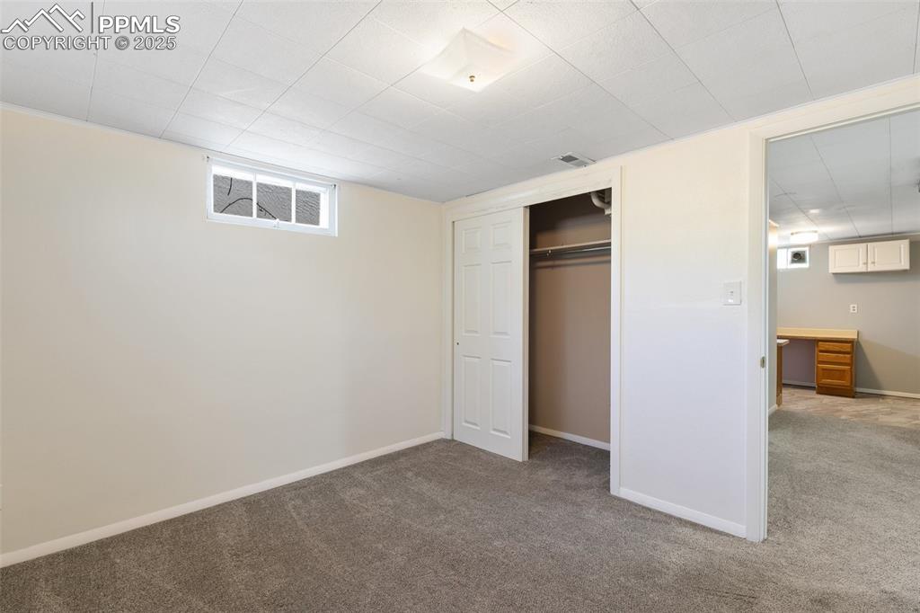 623 Swope Avenue Colorado Springs, CO 80909 - Photo 32 of 39 an empty room with a kitchen