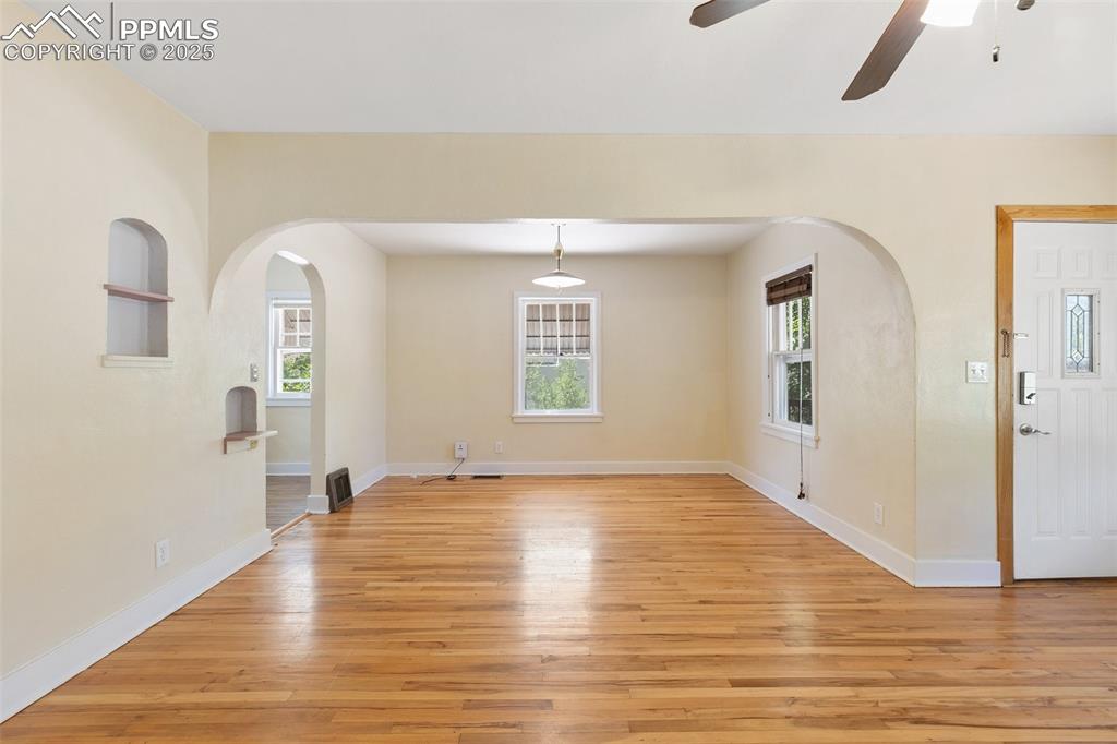 623 Swope Avenue Colorado Springs, CO 80909 - Photo 4 of 39 a view of an empty room with window and wooden floor