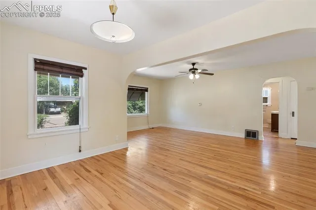 wooden floor in an empty room with a window