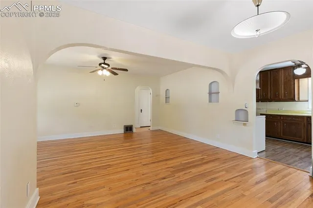 a view of an empty room with a sink and a mirror