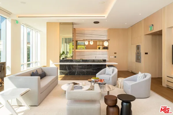a living room with furniture a rug and a large window
