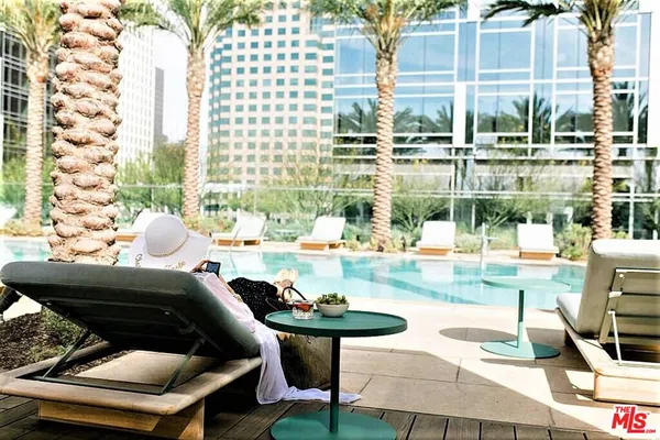 a view of a patio with couches and potted plants
