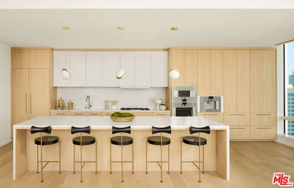 a kitchen with a dining table chairs and white appliances