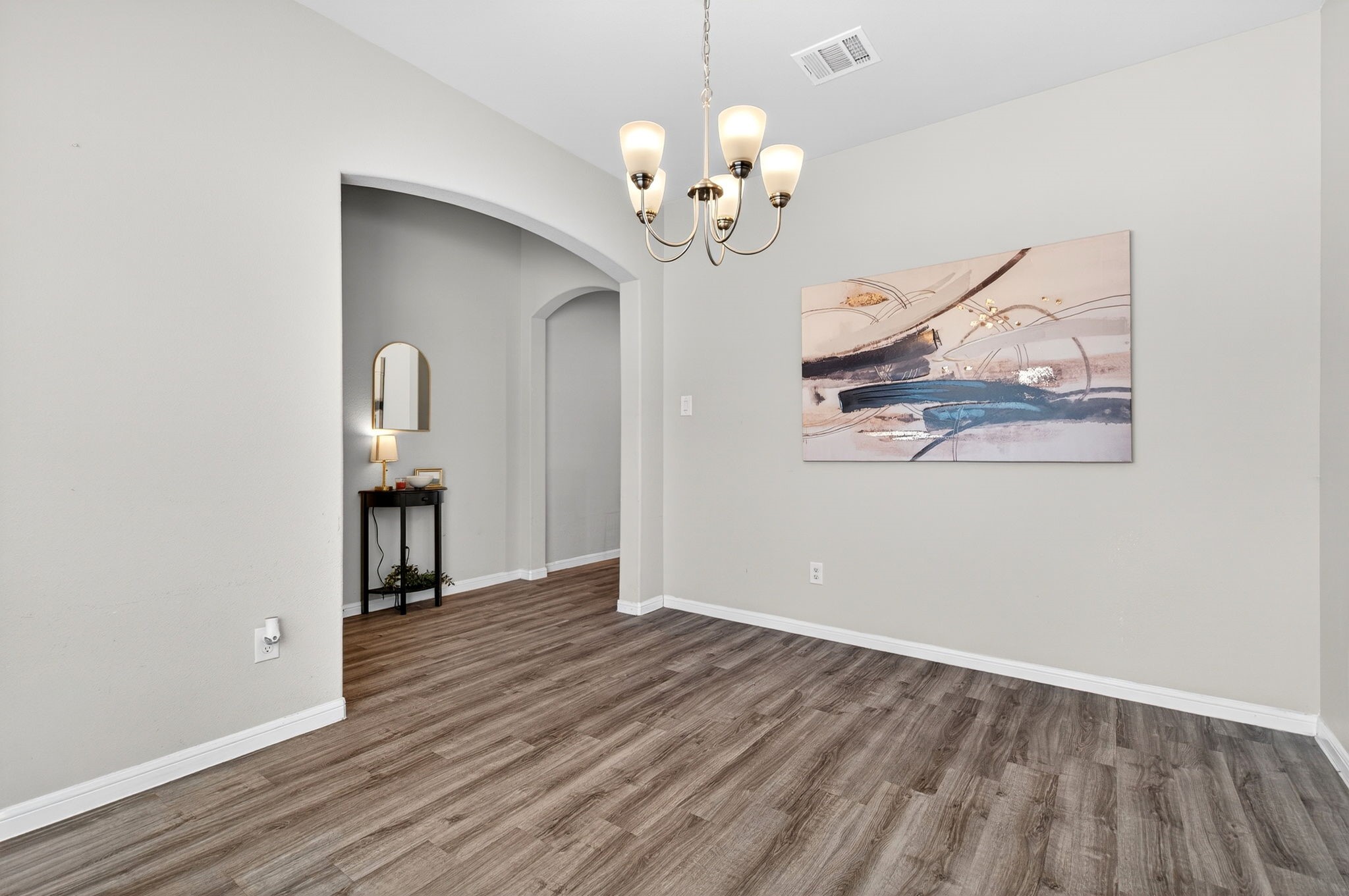 2121 Cedar Way Drive Conroe, TX 77301 - Photo 4 of 27 a view of a room with wooden floor and chandelier