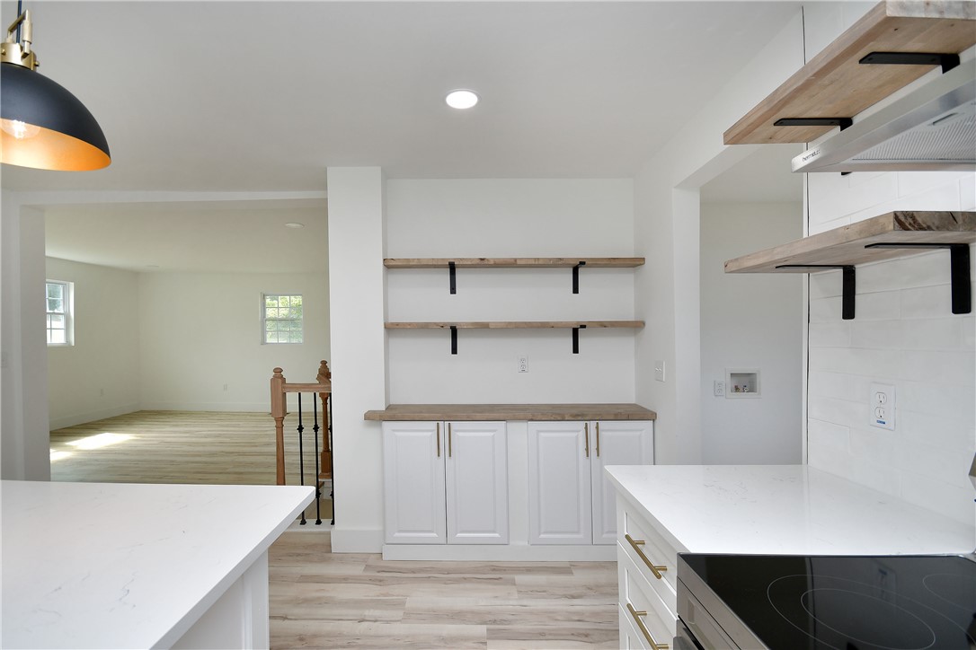 407 I Street Anderson, SC 29625 - Photo 18 of 43 A well-appointed kitchen showcasing elegant white cabinetry, sleek countertops, and practical open shelving.