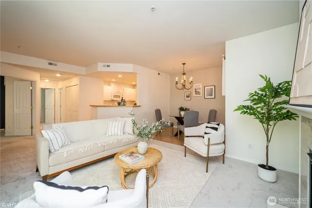 a living room with furniture potted plant and a large window