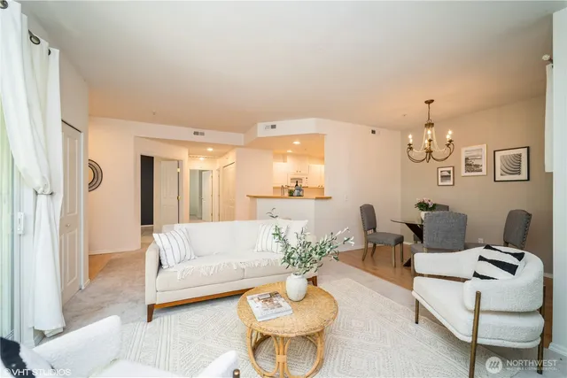 a living room with furniture and a chandelier