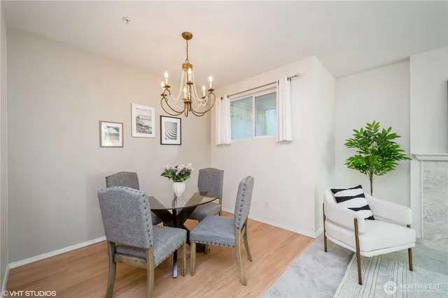 a view of a dining room with furniture wooden floor and a chandelier