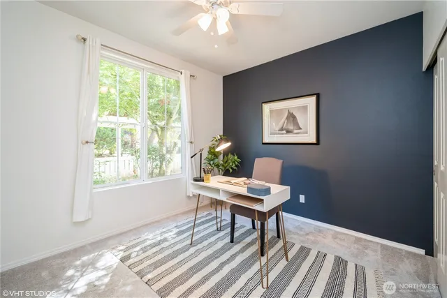 a workspace with wooden floor and a window