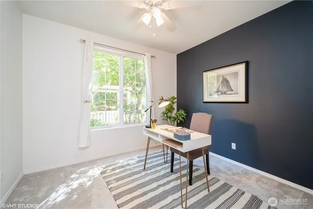 a workspace with wooden floor and a window