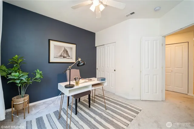 a workspace with furniture and a potted plant