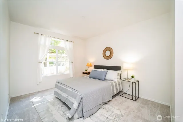 a bedroom with a bed and a window