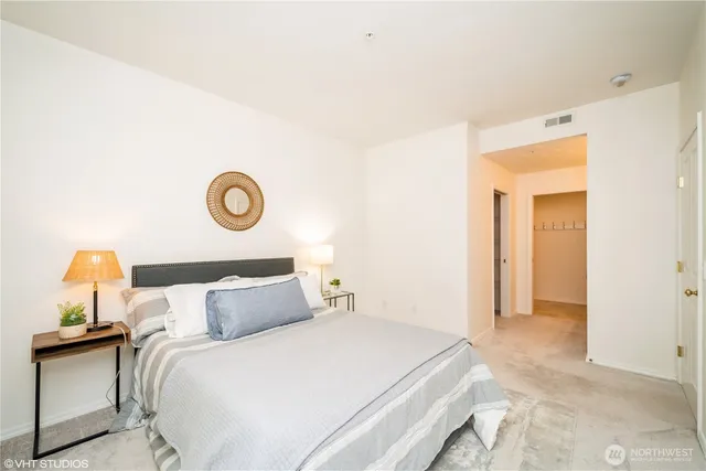 a bedroom with a bed and flowerpot