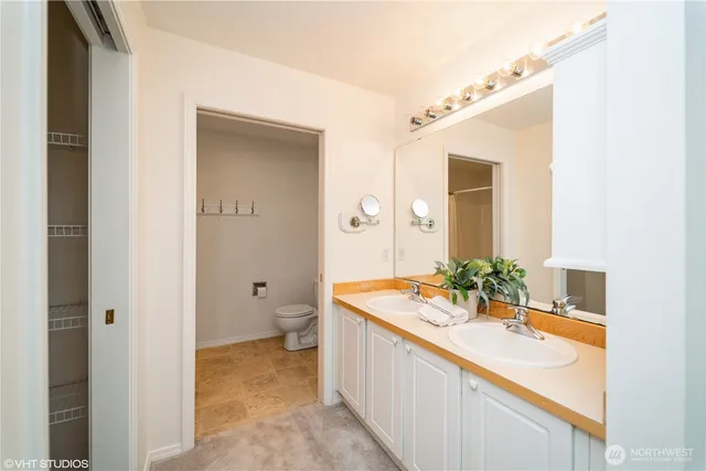 a spacious bathroom with a granite countertop sink and a mirror