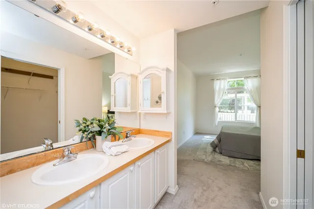 a spacious bathroom with a granite countertop sink and a mirror