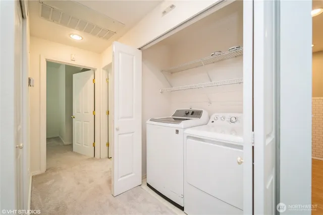 a view of storage and utility room with washer and dryer
