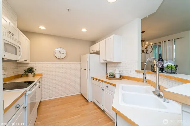 a kitchen with a sink and a stove top oven