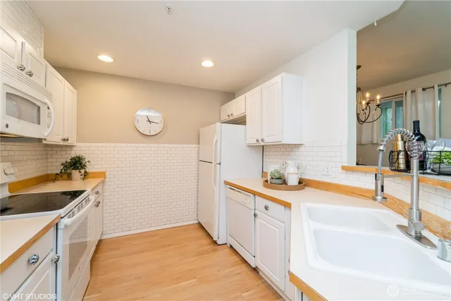 a kitchen with a sink a stove and cabinets