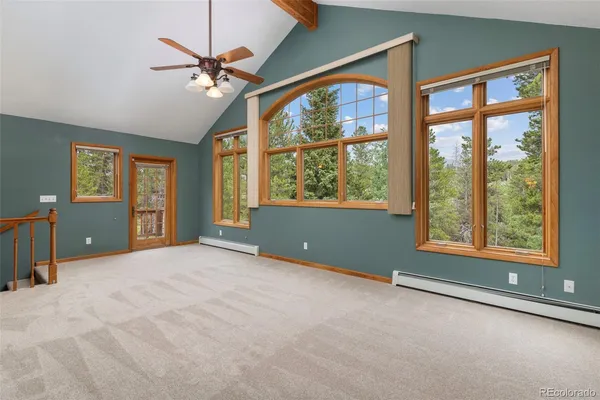an empty room with windows and closet
