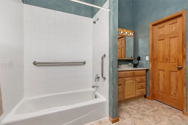 a bathroom with a bathtub and a sink