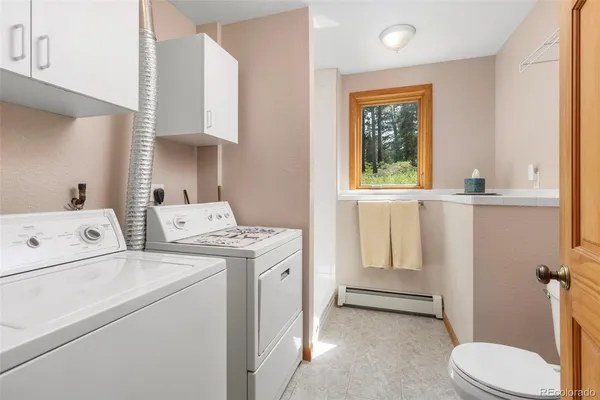 a view of bathroom with a window washer and dryer