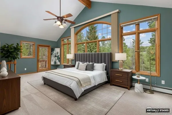 a bedroom with a large bed and a large window