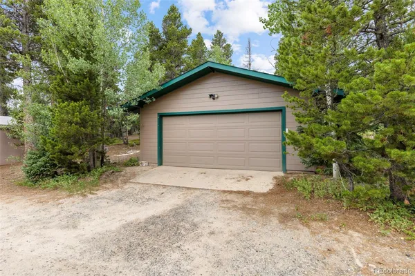 a view of a small house with a yard