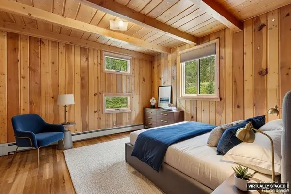 a bedroom with a bed and a chair
