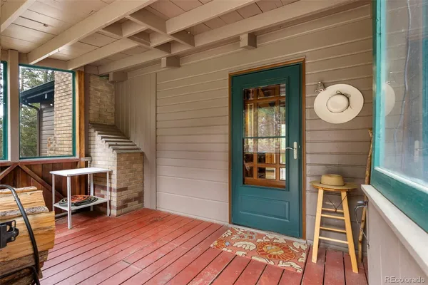 a view of front door and deck with seating space