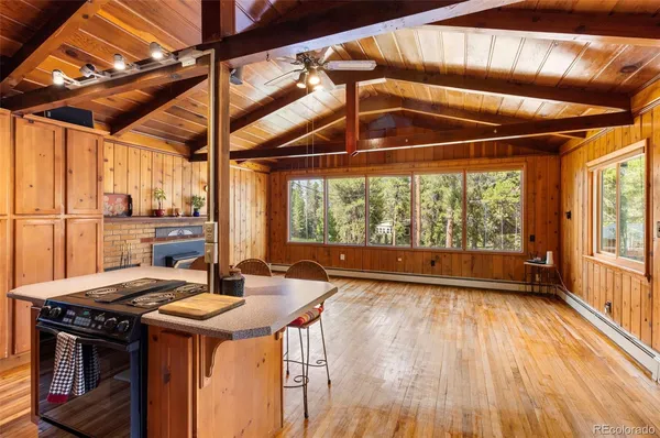 a view of a kitchen with a sink and wooden floor