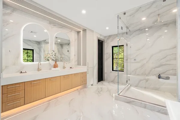 a spacious bathroom with a large tub shower and sink