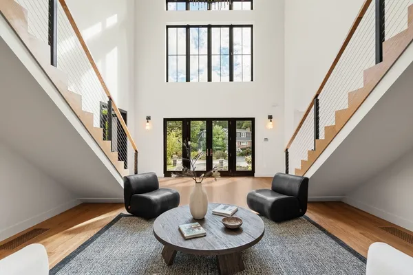 a living room with furniture and a floor to ceiling window